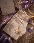 Celestia Sunburst Pink Crystal Pendant Necklace featuring a pink centre stone, sparkling crystal accents and a gold-tone sun-inspired design.