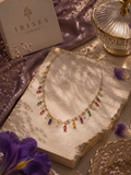 Gold-tone rainbow crystal charm necklace with multicolour baguette-shaped crystals by Irises Jewels.