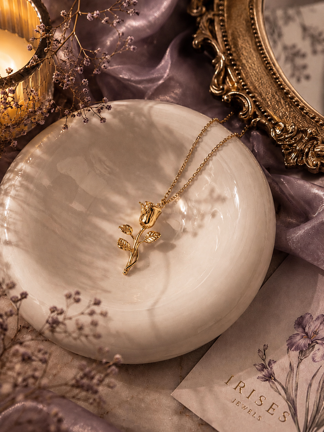 Golden Rose Bloom pendant necklace with elegant gold rose flower pendant displayed on a marble tray.