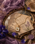 Gold butterfly pendant necklace with pearl-inspired square charm on a delicate gold chain.