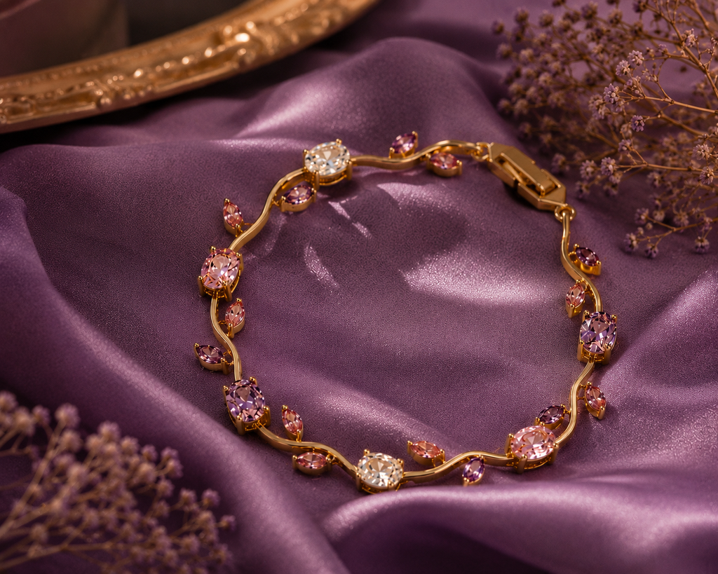Gold floral bracelet with lavender, blush pink, and crystal stones arranged in a delicate tulip-inspired design on a beige marble surface.